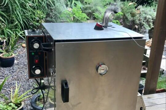 Electric smoker in the backyard smoking some fresh snapper wings.